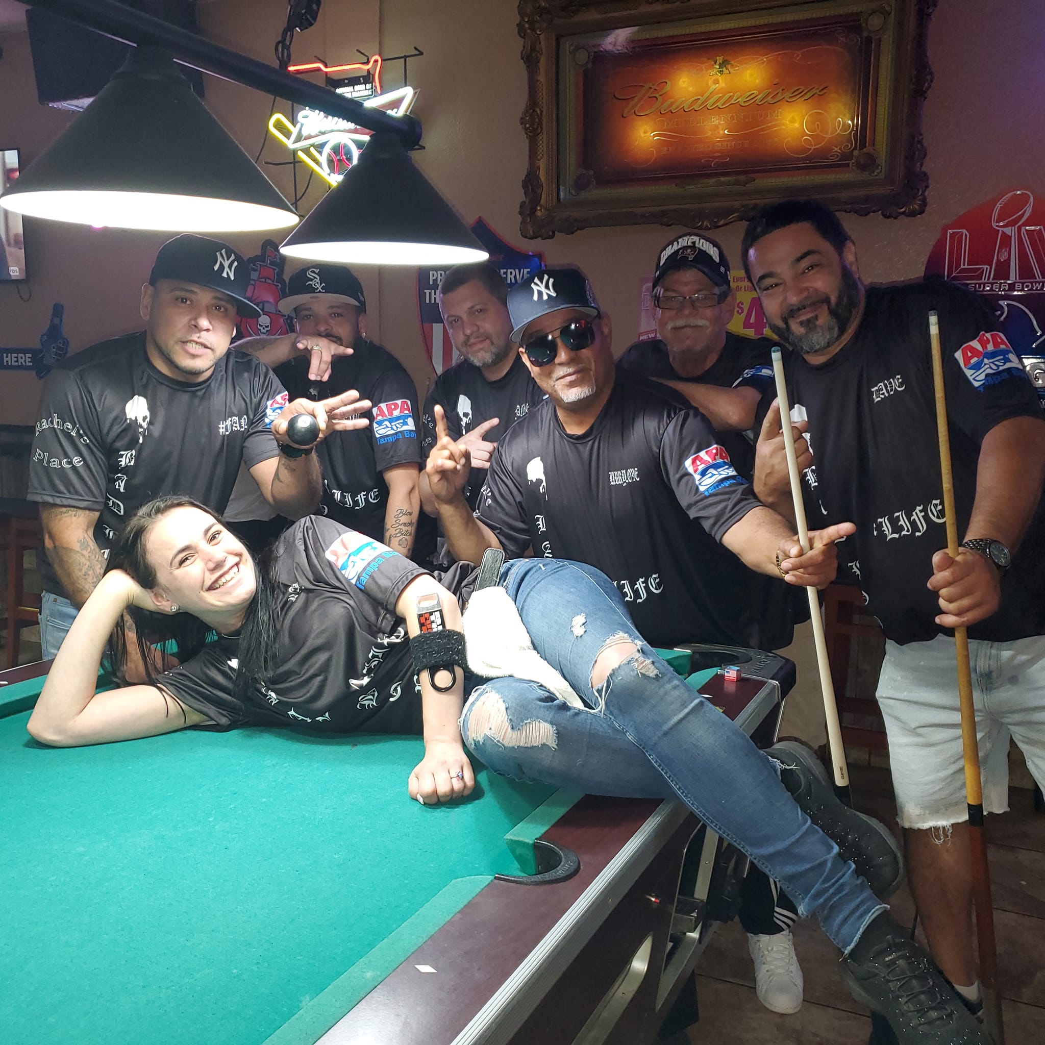 An APA league team gathered around the pool table on team night.